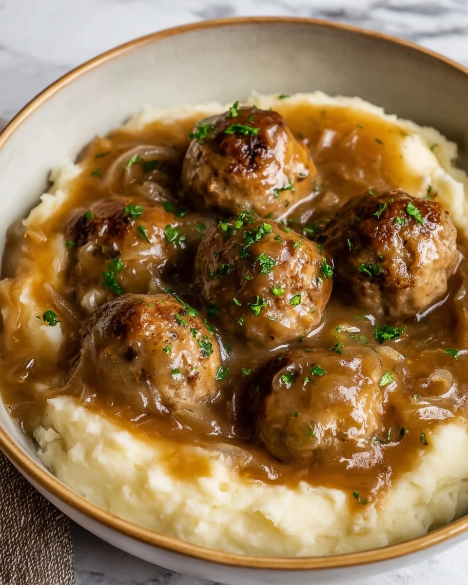 The image shows a bowl filled with three layers. The bottom layer is smooth, creamy mashed potatoes in a light off-white color. The middle layer consists of a thick brown gravy with visible translucent onion slices spread over the mashed potatoes. On top, there are six round meatballs, browned and slightly textured, coated with the same brown gravy. Small green parsley bits are sprinkled over the meatballs and gravy for extra color. The bowl is white with a light brown rim, and the background is a white marbled texture. Photo taken with an iphone --ar 4:5 --v 7