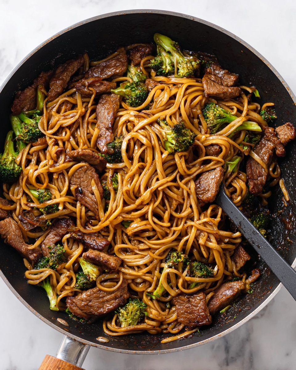 The image shows two white plates filled with stir-fried noodles mixed with pieces of browned beef and bright green broccoli florets. The noodles are coated in a shiny, dark sauce that gives them a rich brown color. The beef pieces have a seared, slightly charred look, adding texture to the dish. The broccoli adds a fresh green color scattered evenly throughout the noodles. White sesame seeds are sprinkled on top, adding a speckled touch against the darker noodles and beef. A silver fork rests on the right side of the front plate, with some noodles wrapped around its tines. In the top right corner, a cloth with a floral, orange and brown pattern lies softly on the white marbled surface under the plates. photo taken with an iphone --ar 4:5 --v 7
