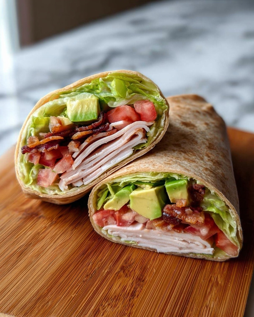 A sandwich wrap cut in half, positioned on a wooden board over a white marbled surface, shows several visible layers. The outer layer is a light brown tortilla, surrounding fresh green lettuce and bright red diced tomatoes. Inside, there are thin slices of white turkey meat folded neatly, topped with crispy brown bacon, creamy green avocado chunks, and more lettuce near the top. The wrap halves are angled to show the inside fillings clearly. Photo taken with an iphone --ar 4:5 --v 7