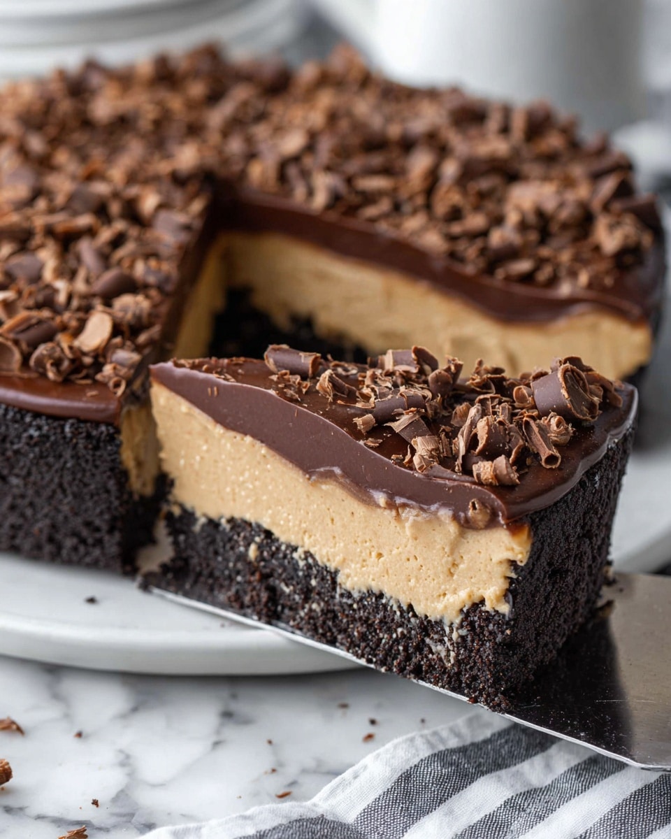 A close-up view of a three-layer chocolate tart slice. The bottom layer is a thick, dark crumbly chocolate crust. Above it is a smooth, creamy light brown filling layer. The top layer is a shiny dark chocolate ganache, covered with many small, curled milk chocolate shavings scattered evenly. The slice is partially lifted on a metal server, with more tart pieces visible in the background on a white plate, all set on a white marbled texture. Photo taken with an iphone --ar 4:5 --v 7
